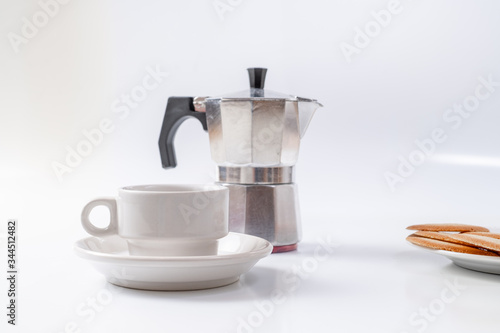coffee maker white breakfast cup and cookies on background