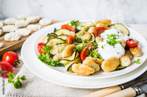 gnocchi with zucchini and cherry tomatoes on a plate