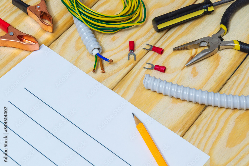 Drawing up a plan for the repair of electrical equipment with spare parts and tools on wooden boards Drawing up a plan for the repair of electrical equipment with spare parts and tools on wooden boards