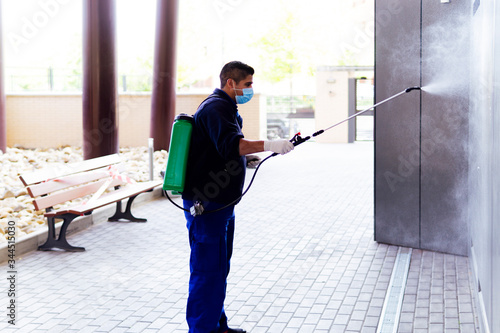 coronavirus. maintenance personnel disinfecting to prevent the spread of covid19