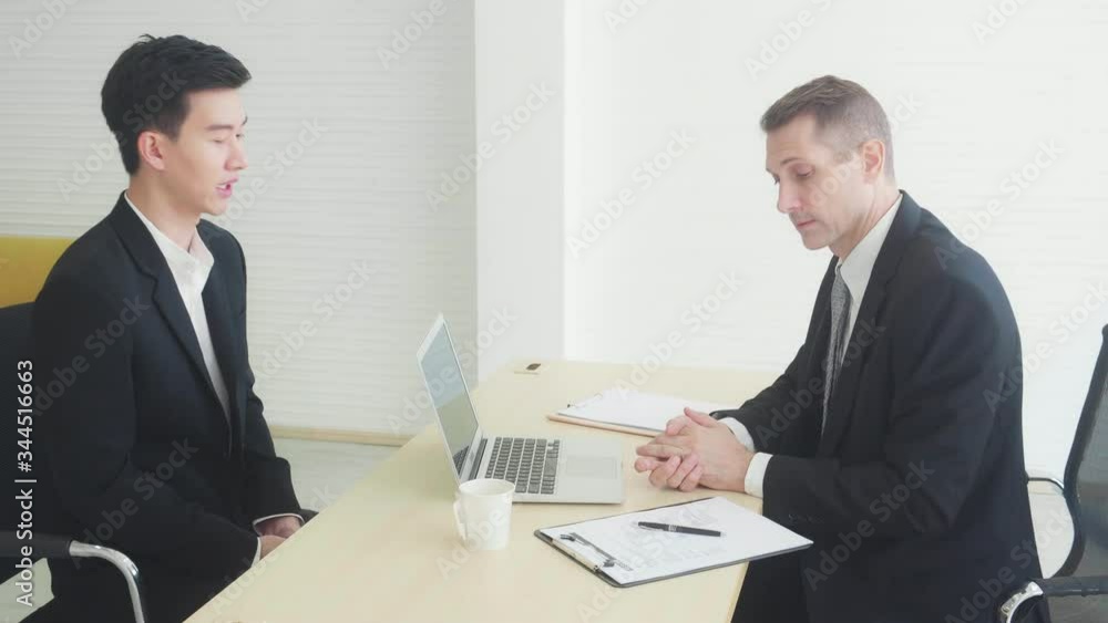 Young asian businessman job interview with manager at the office, executive and candidate talking, recruitment and employee, negotiation and consulting, business man discussion with boss in corporate. Young asian businessman job interview with manager at the office, executive and candidate talking, recruitment and employee, negotiation and consulting, business man discussion with boss in corporate.