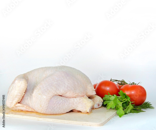 raw chicken on a wooden board