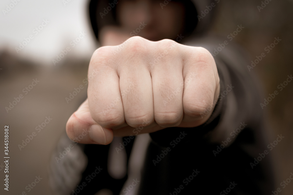 Hand clenched a fist. male punch close up