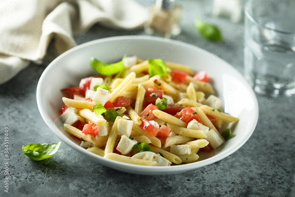 Pasta salad with tomato, mozzarella and basil Pasta salad with tomato, mozzarella and basil