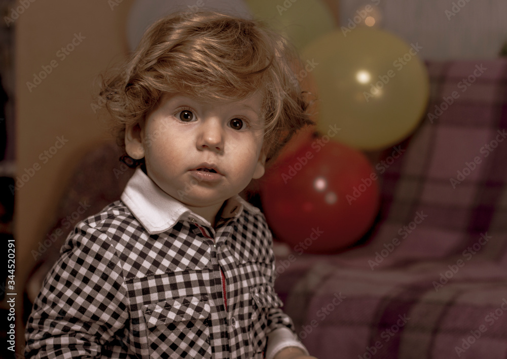A child is celebrating his birthday. Portrait of a little boy with colorful balloons. Retro photo. A child is celebrating his birthday. Portrait of a little boy with colorful balloons. Retro photo.