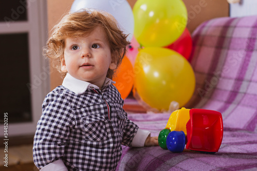 A child is celebrating his birthday. Portrait of a little boy with colorful balloons.