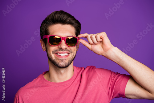 Portrait of positive candid macho man touch cool stylish specs look good attract beautiful women wear stylish clothes isolated over bright color background © deagreez