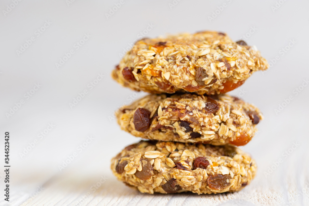 Homemade tasty oatmeal cookies with rasins, dried apricots and date fruits. Healthy snack concept. Sweet dessert. Close up