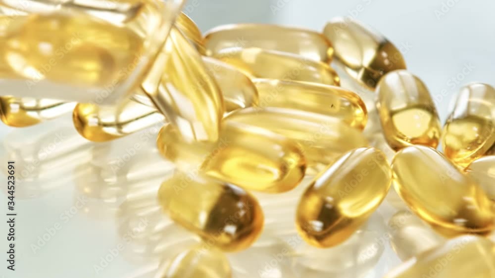 Spill heap of transparent yellow capsule with omega supplement. Shot with RED camera in 4K Spill heap of transparent yellow capsule with omega supplement. Shot with RED camera in 4K