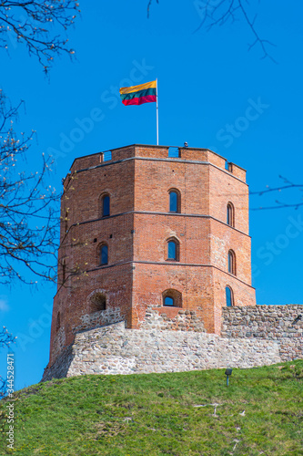 Gediminas Tower or Castle, the remaining part of the Upper Medieval Castle in Vilnius, Lithuania with Lithuanian flag, vertical