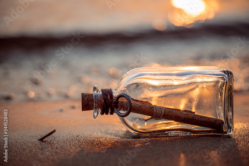 Message in the bottle against the Sun setting down