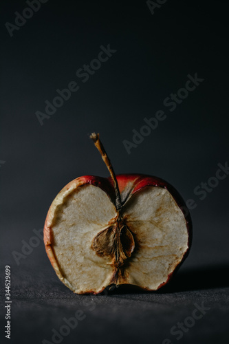 Macro half dry apple on a dark background. vertically. space for text on the top.