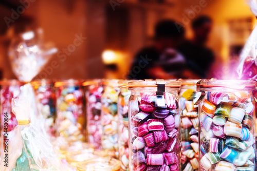 Blur background of delicious sweet beautiful fantasy colourful jar box of candy treat for summer holiday kids gift souvenir. Eat too much bonbon lollipop sugar is toxic unhealthy nutrition addiction