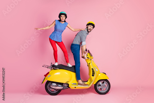 Full size profile side photo of positive cheerful two people bikers stand on funky motor bike drive fast speed enjoy road adventure scream wow omg isolated over pastel color background