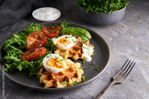 Healthy organic breakfast. Waffles, herbs, tomatoes,salad,eggs, spices served in a plate photo