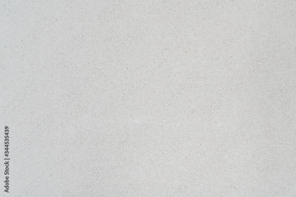 Gray color background from sheet of recycled cardboard. Close-up detail view of abstract texture recycled carton material pattern background. Gray color background from sheet of recycled cardboard. Close-up detail view of abstract texture recycled carton material pattern background.