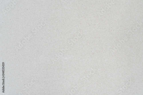 Gray color background from sheet of recycled cardboard. Close-up detail view of abstract texture recycled carton material pattern background.