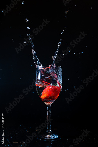 Strawberry splash water.  Strawberry pouring into glass.