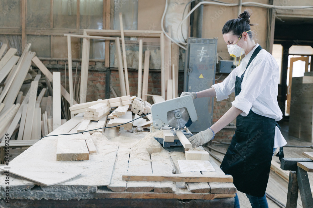 Confident woman working as carpenter in her own woodshop Confident woman working as carpenter in her own woodshop