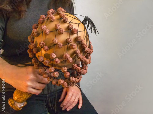 musician woman playing on calabash maracas, Exotic female Performing Hawaiian Music, close-up photography