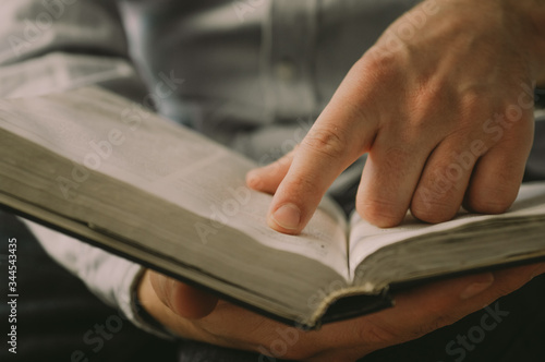 The Christian holds the Bible in his hands. Reading the bible. The concept of faith