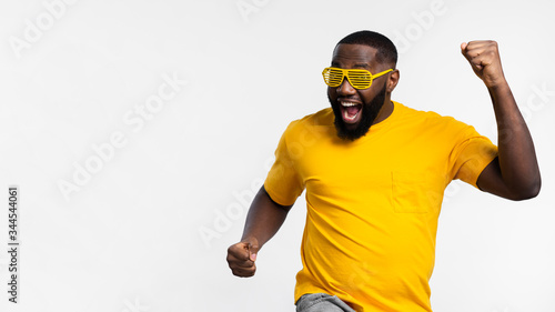 Copy-space black man celebrating. Happiness, yellow day.