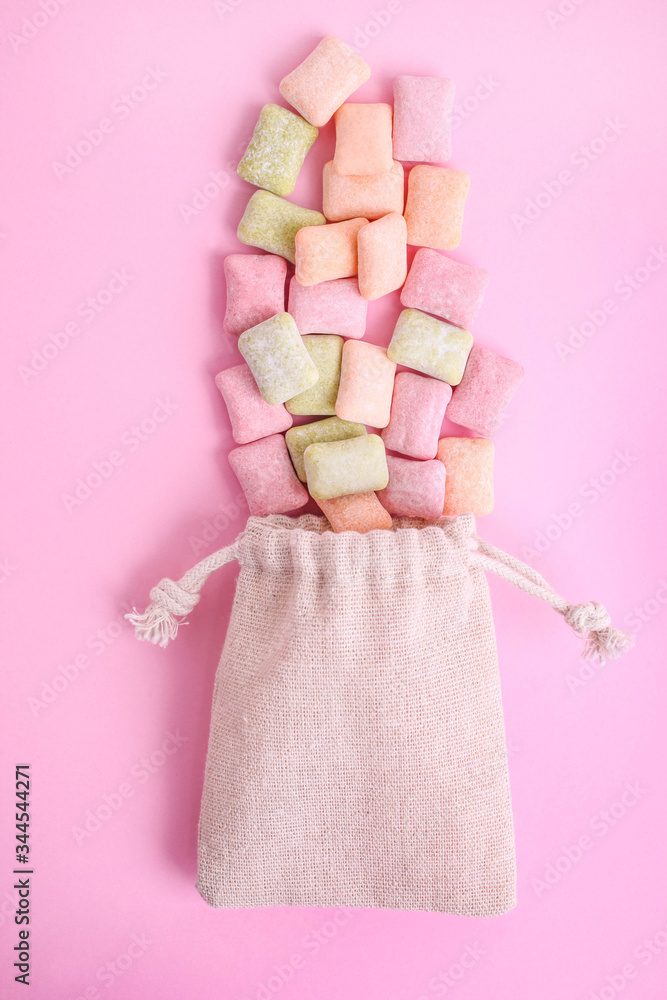Pillows of multi-colored chewing gum in a fabric eco bag Pillows of multi-colored chewing gum in a fabric eco bag