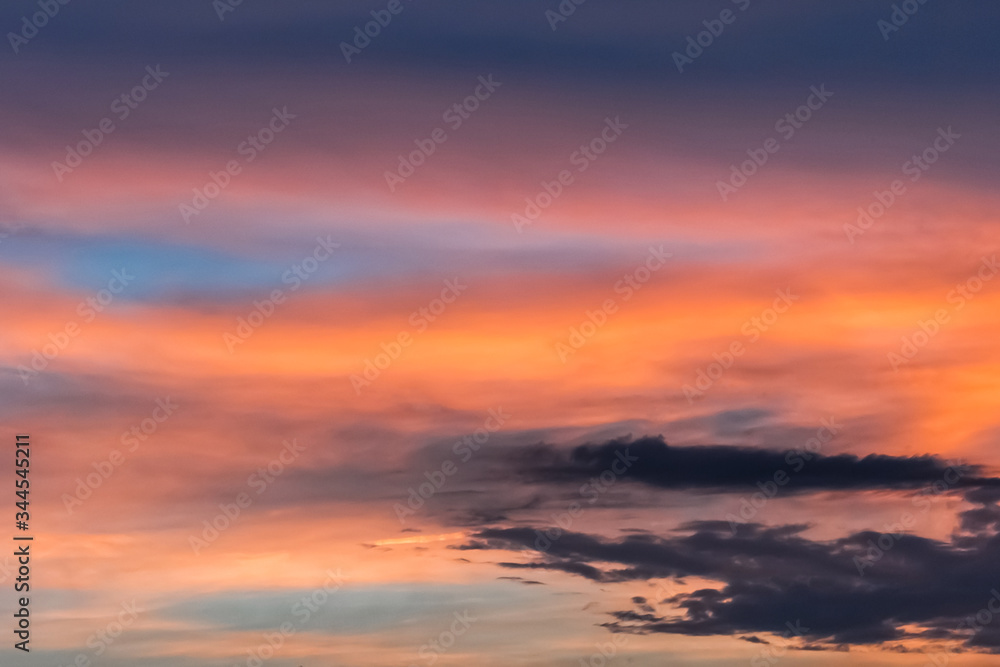 Colorful sunset on a beautiful summer sky with dark evening clouds after rain Colorful sunset on a beautiful summer sky with dark evening clouds after rain