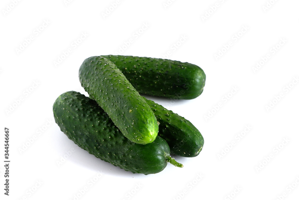 Green cucumbers on a white background. Vegetables Green cucumbers on a white background. Vegetables