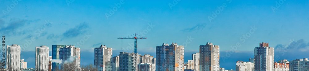 Construction of modern buildings in a new micro district of the city, tower crane, panoramic view, high 
