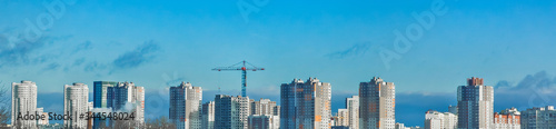 Construction of modern buildings in a new micro district of the city, tower crane, panoramic view, high 