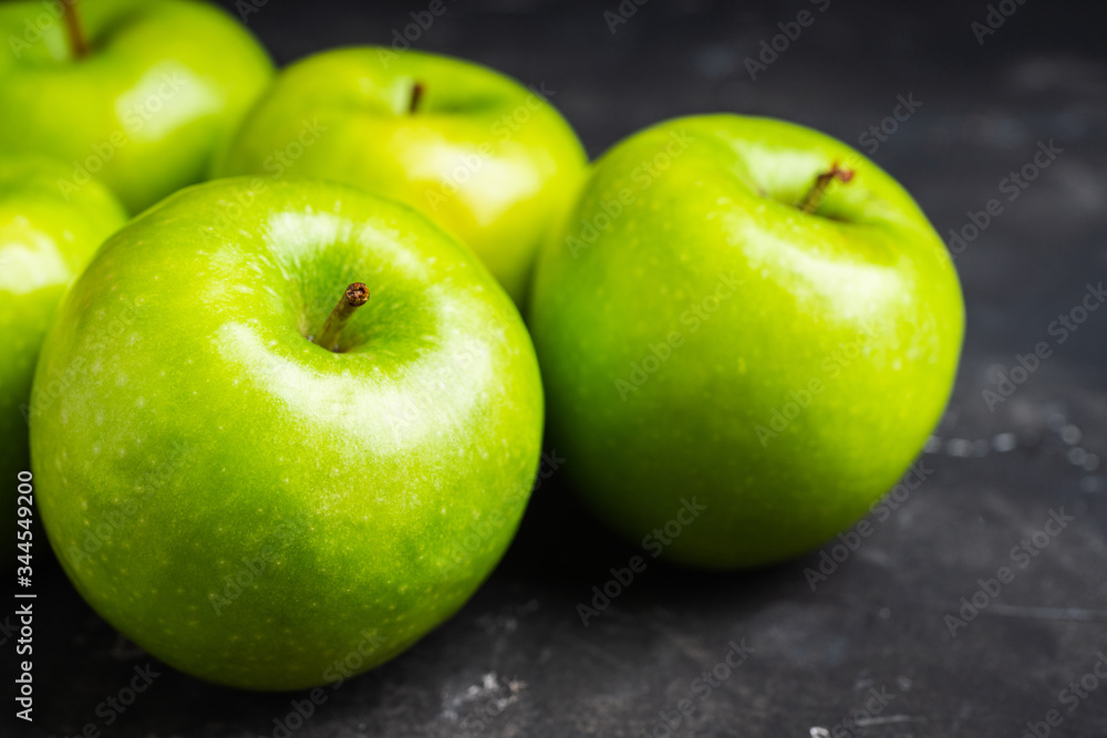 Close-up green apples on the rustic wooden background. Selective focus. Shallow depth of field. Close-up green apples on the rustic wooden background. Selective focus. Shallow depth of field.