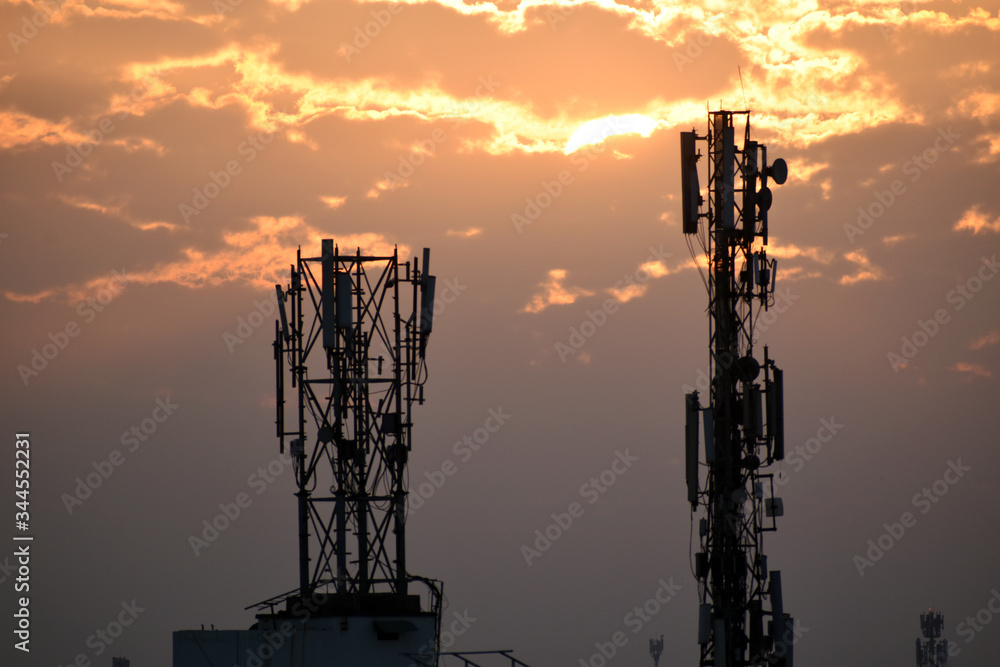 Sunrise behind mobile tower in the city Sunrise behind mobile tower in the city