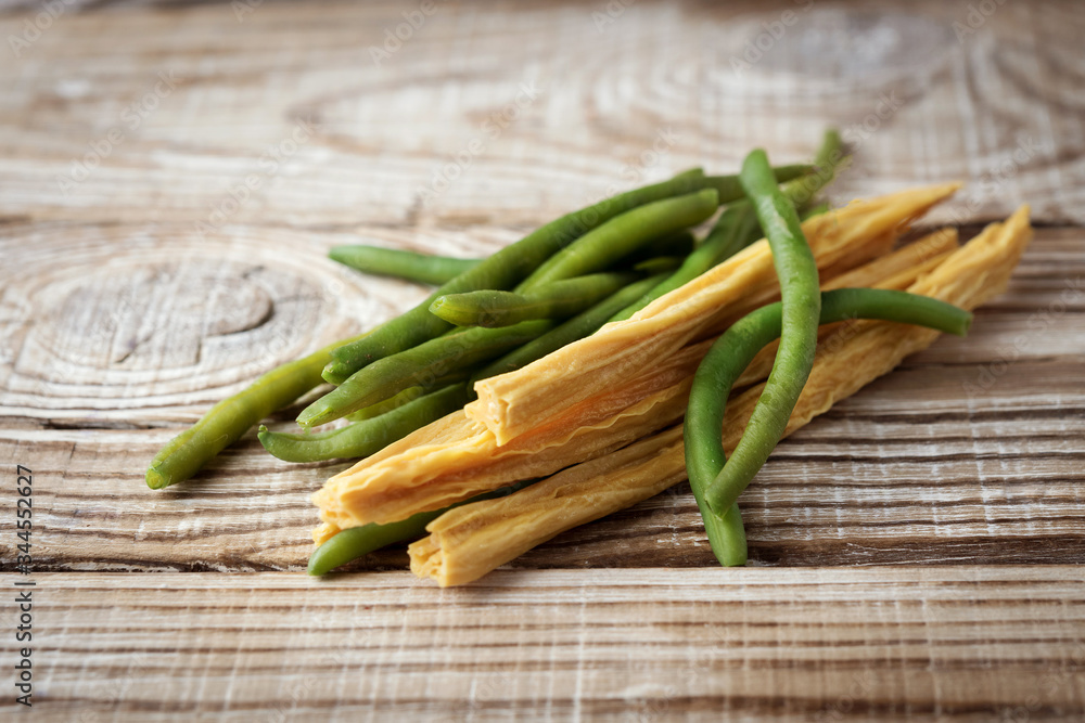 asparagus and green beans on a wooden background asparagus and green beans on a wooden background