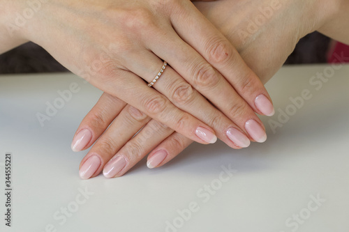 Female hands with manicure. Stacked on top of each other. Shot close up.