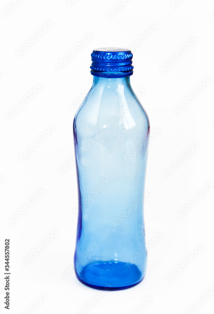 glass blue bottle with an iron lid on a white background glass blue bottle with an iron lid on a white background