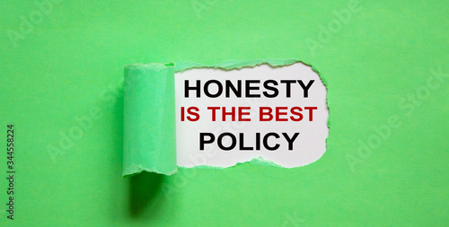 The text 'honesty is the best policy' appearing behind torn green paper.