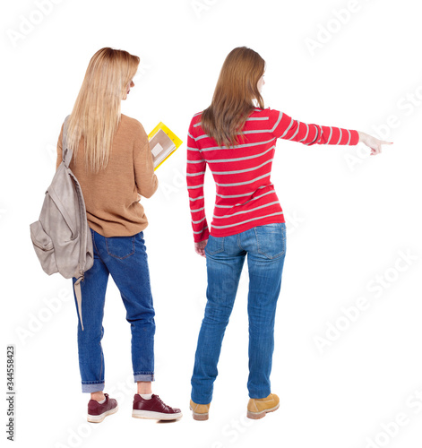 Back view of two pointing girl in sweater.