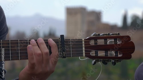 Close-up of the hand of a street flamenco guitarist playing the guitar in the viewpoint of San Nicolás del Albaicín Granada.