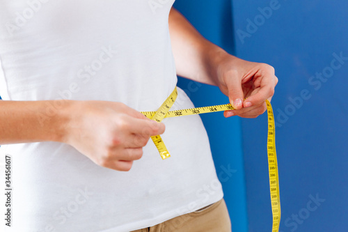 Bilde på lerret Women healthy body care weight control measuring waist fat using tape measure or measuring tape