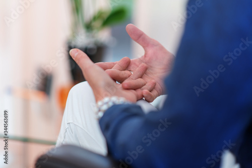 woman's hands clasped during psychological counseling