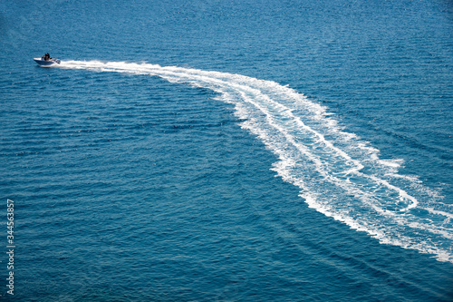 speedboat runs fast in the open sea and leaves the engine's wake in the water © FV Photography