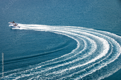 two speedboat runs fast in the open sea and leaves the engine's wake in the water