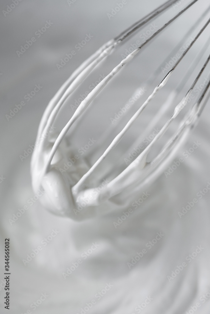 Close up shoot of whisk in cream Close up shoot of whisk in cream