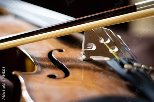 Artful close-up photo of a violin body and bow