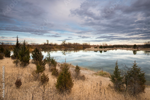 Sunset clouds reflected in the surface of a calm lake.