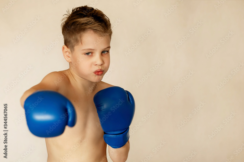 A school-aged boy is boxing at home during quarantine. Sport is not a hindrance. Willpower is brought up by training. A school-aged boy is boxing at home during quarantine. Sport is not a hindrance. Willpower is brought up by training.