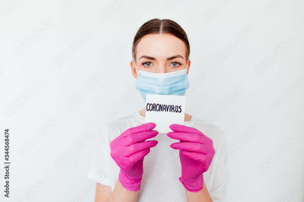 Coronavirus concept. Close up of doctor hands holding paper with coronavirus text written on it. Coronavirus concept responsible for flu outbreak and coronaviruses influenza. Impact of pandemic virus.