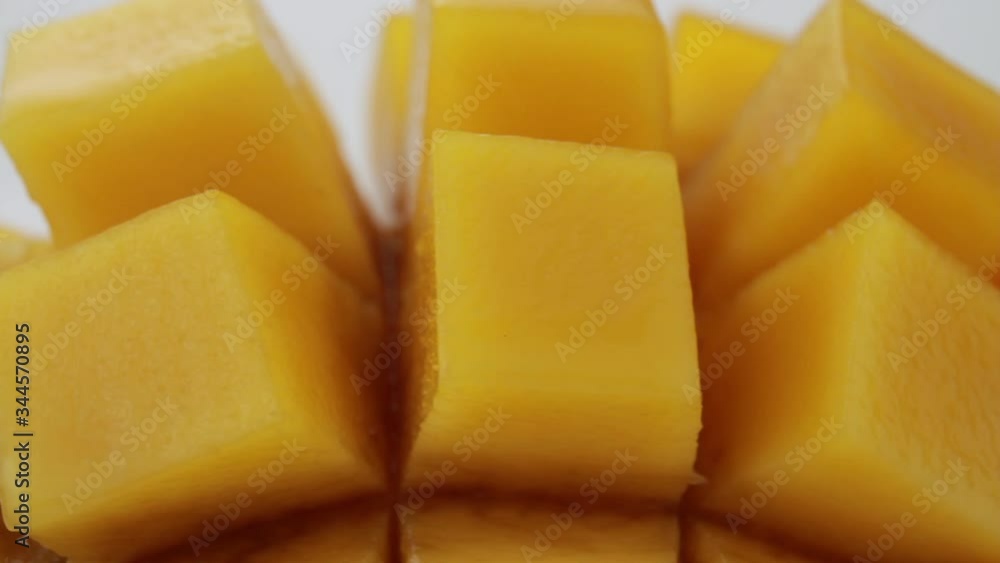 Ripe mango cube slice turning on white background, Mango juice and tropical fruit product concept. Ripe mango cube slice turning on white background, Mango juice and tropical fruit product concept.