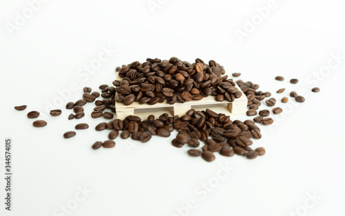 Coffee beans lying on on small wooden pallet